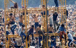 People climbing on scaffolding at Woodstock