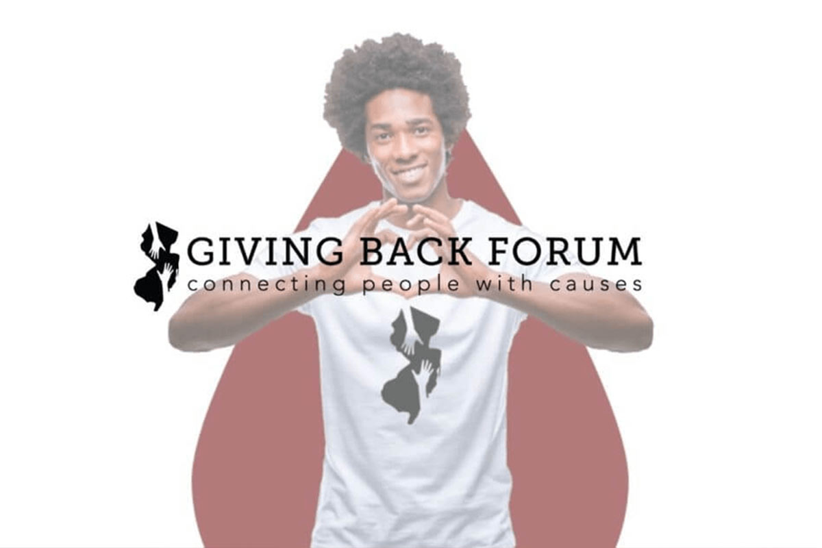 Man with hands in shape of a heart; Giving Back Forum