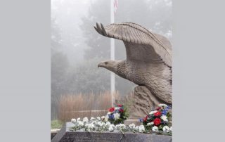 Eagle statue, American flag pole in background