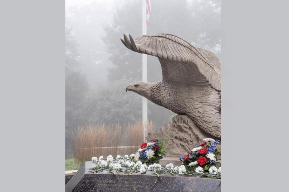 Eagle statue, American flag pole in background