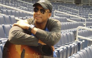 Bernie Williams sitting in baseball stadium