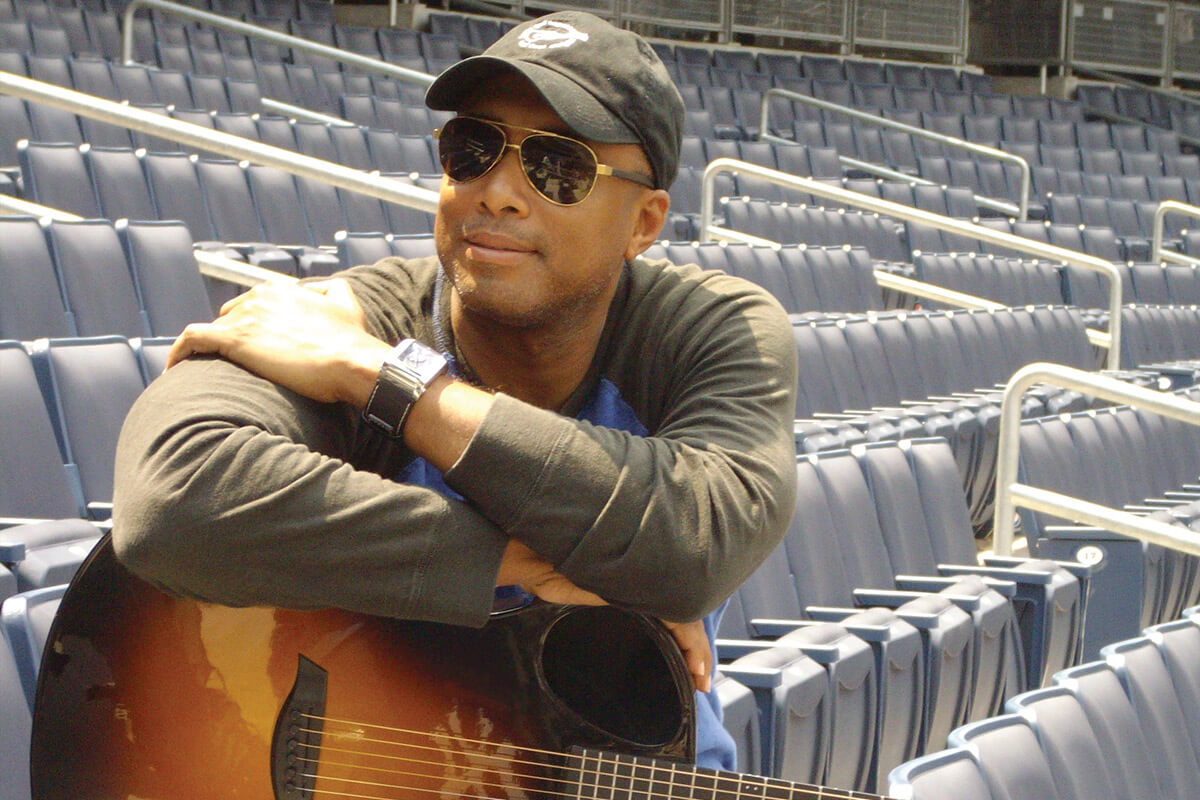 Bernie Williams sitting in baseball stadium