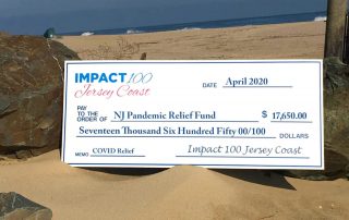 Donation check on beach background