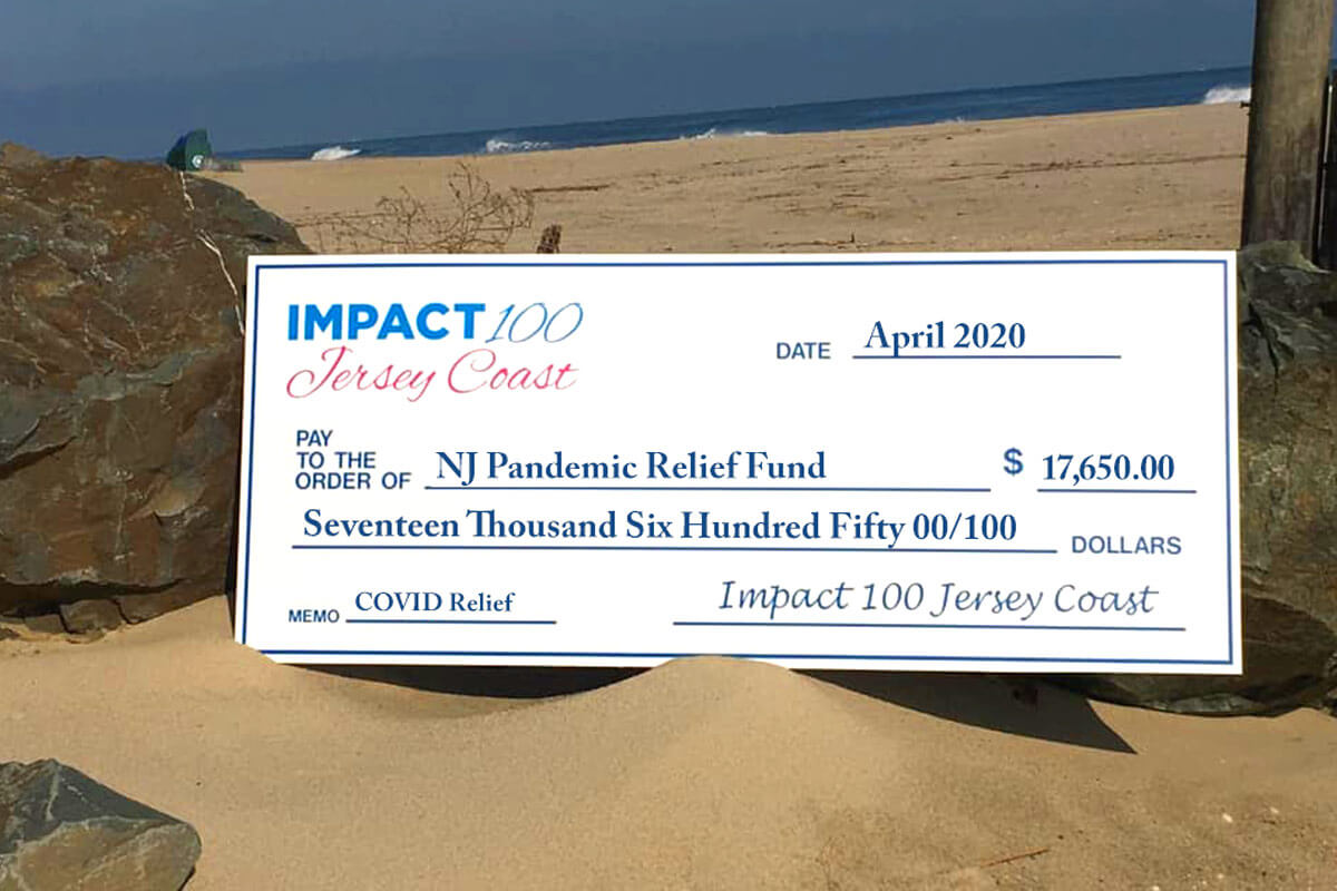 Donation check on beach background