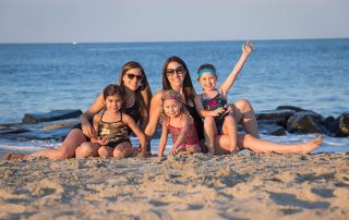 Group of moms and daughters on beach