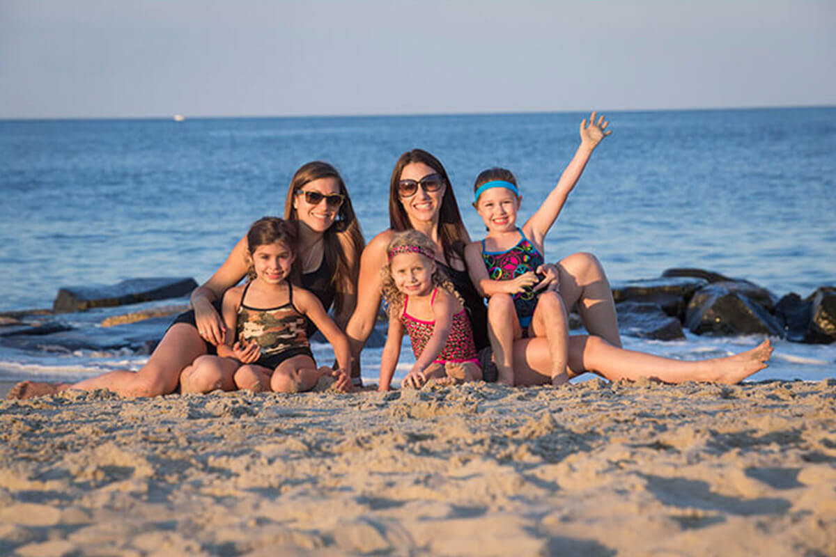 Group of moms and daughters on beach