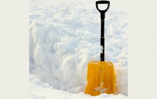 Yellow shovel in the snow