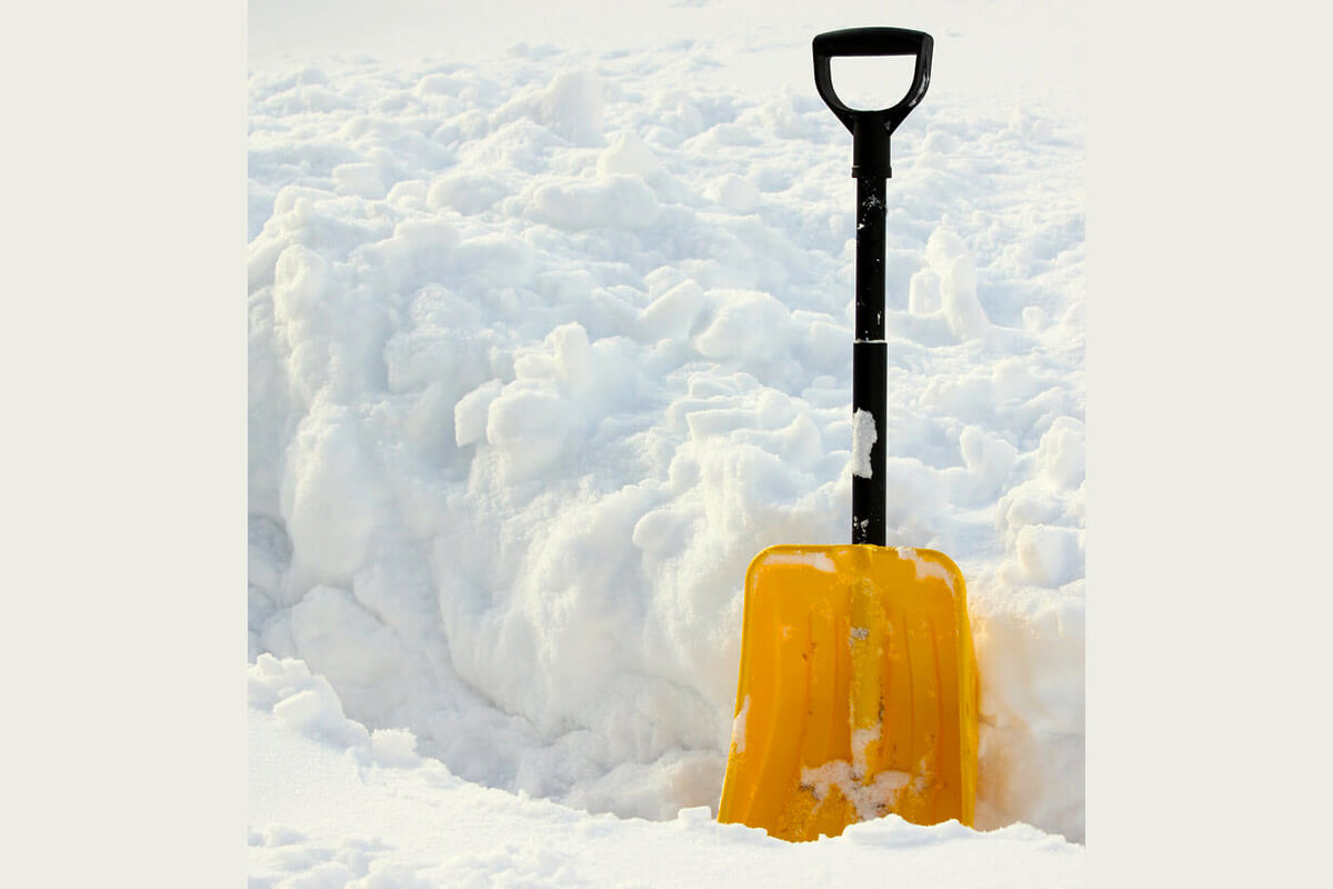 Yellow shovel in the snow