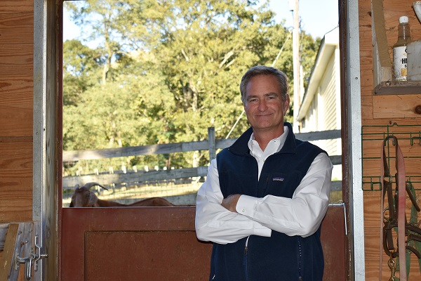 Andy Kaiser in barn crossing arms