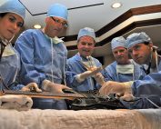 Doctors operating on guitar in emergency room