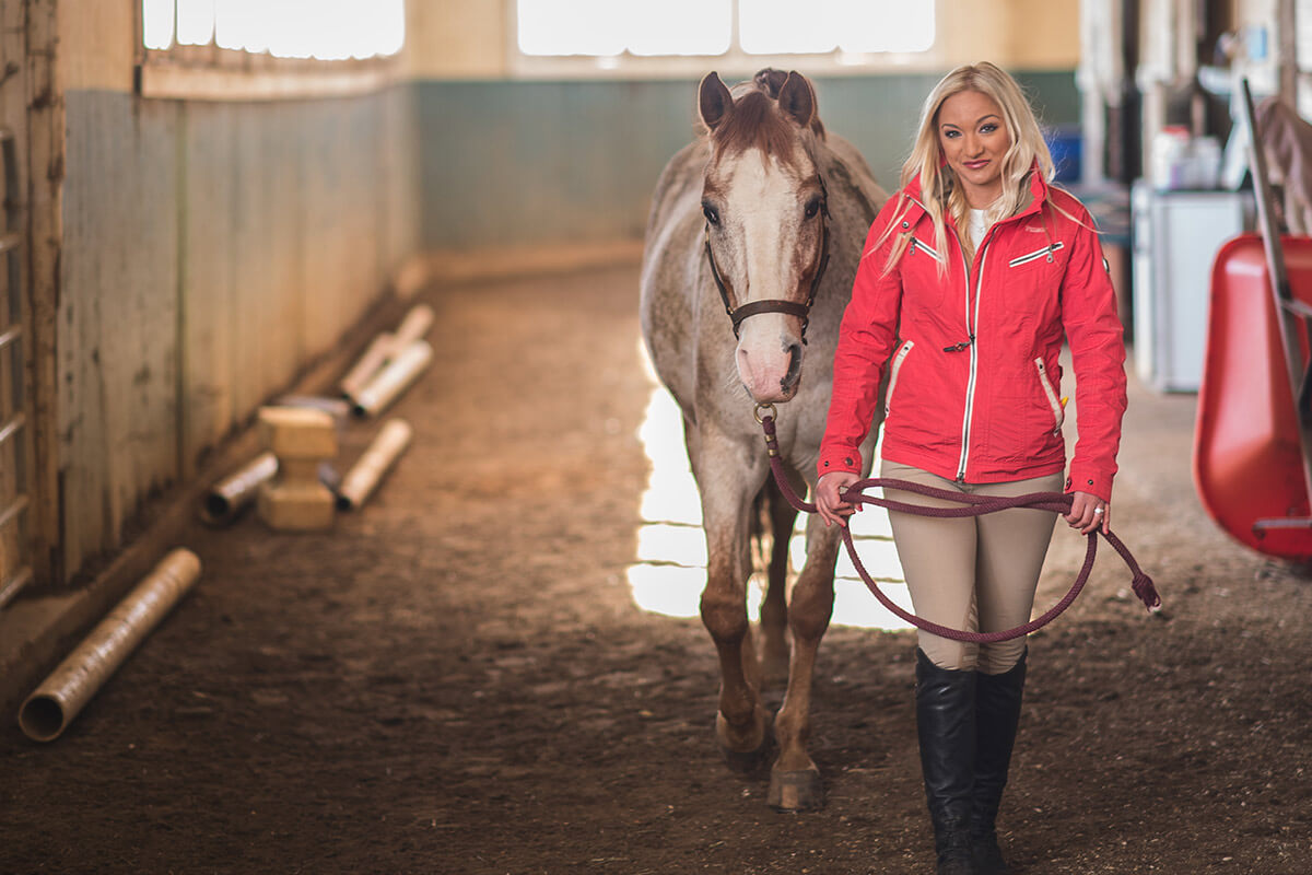 Portrait of Connie DeMaio in horse stable