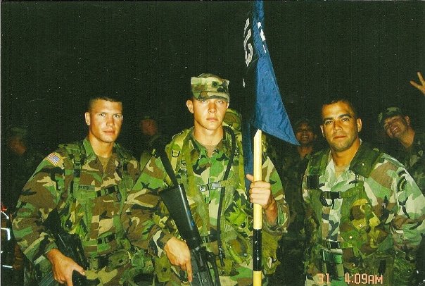 Pete Hegseth posing with fellow soilders, in army uniform