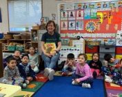 Abby Daly reading a book to children