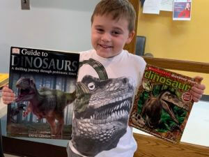 Child holding two books