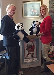 Women donating toys to Toys for Tots