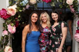 CASA Garden group photo (3 ladies) under flower arch