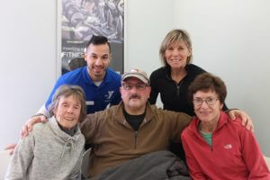 Family posing with YMCA instructor