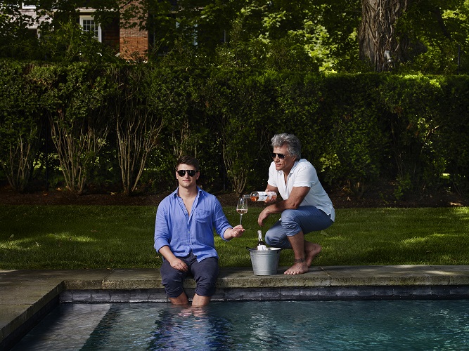 Jon Bon Jovi and his son, Jesse Bongiovi, posing by the pool