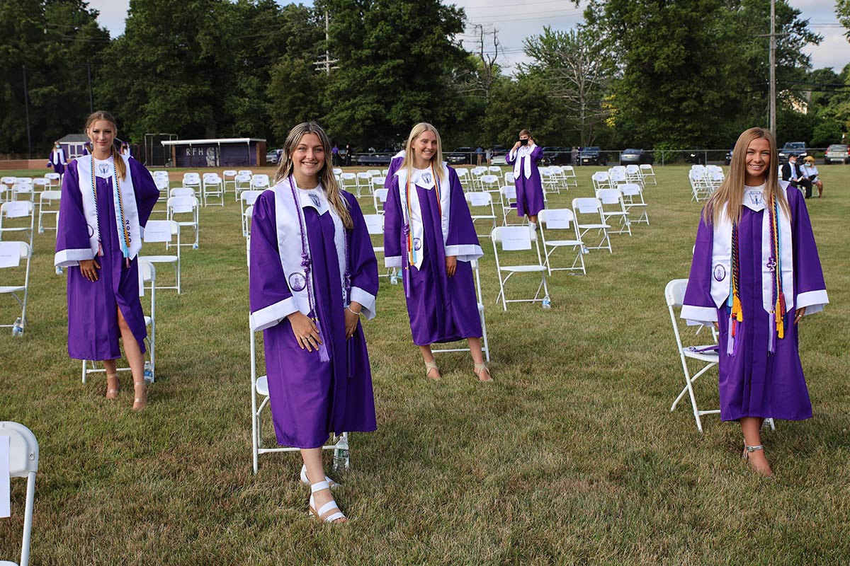 Students at graduation by chairs